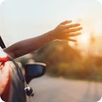 Hand outside vehicle window. 
